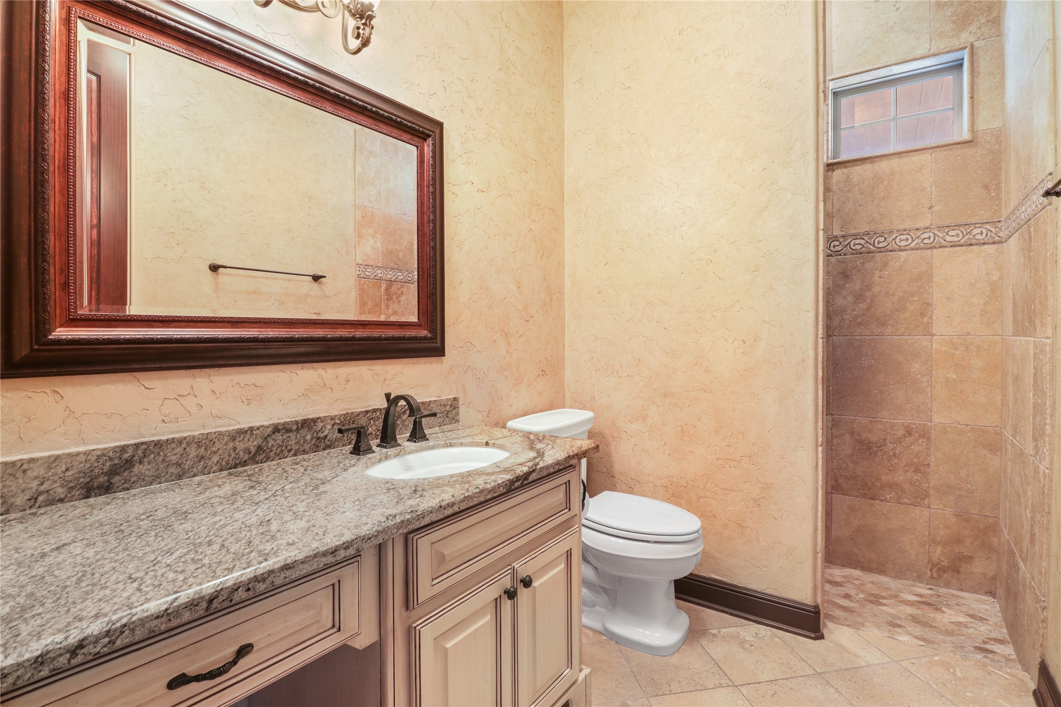 26325 Bauer Hockley Road Hockley, TX 77447 - Photo 29 of 40 a bathroom with a granite countertop sink a toilet and a mirror