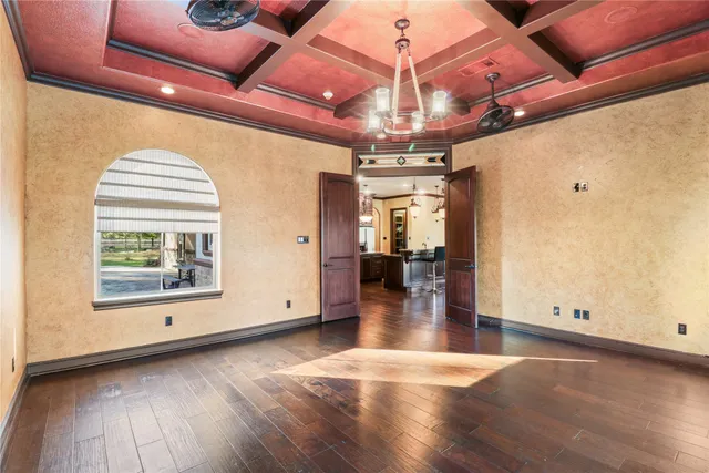 a kitchen with a stove a refrigerator and wooden floor