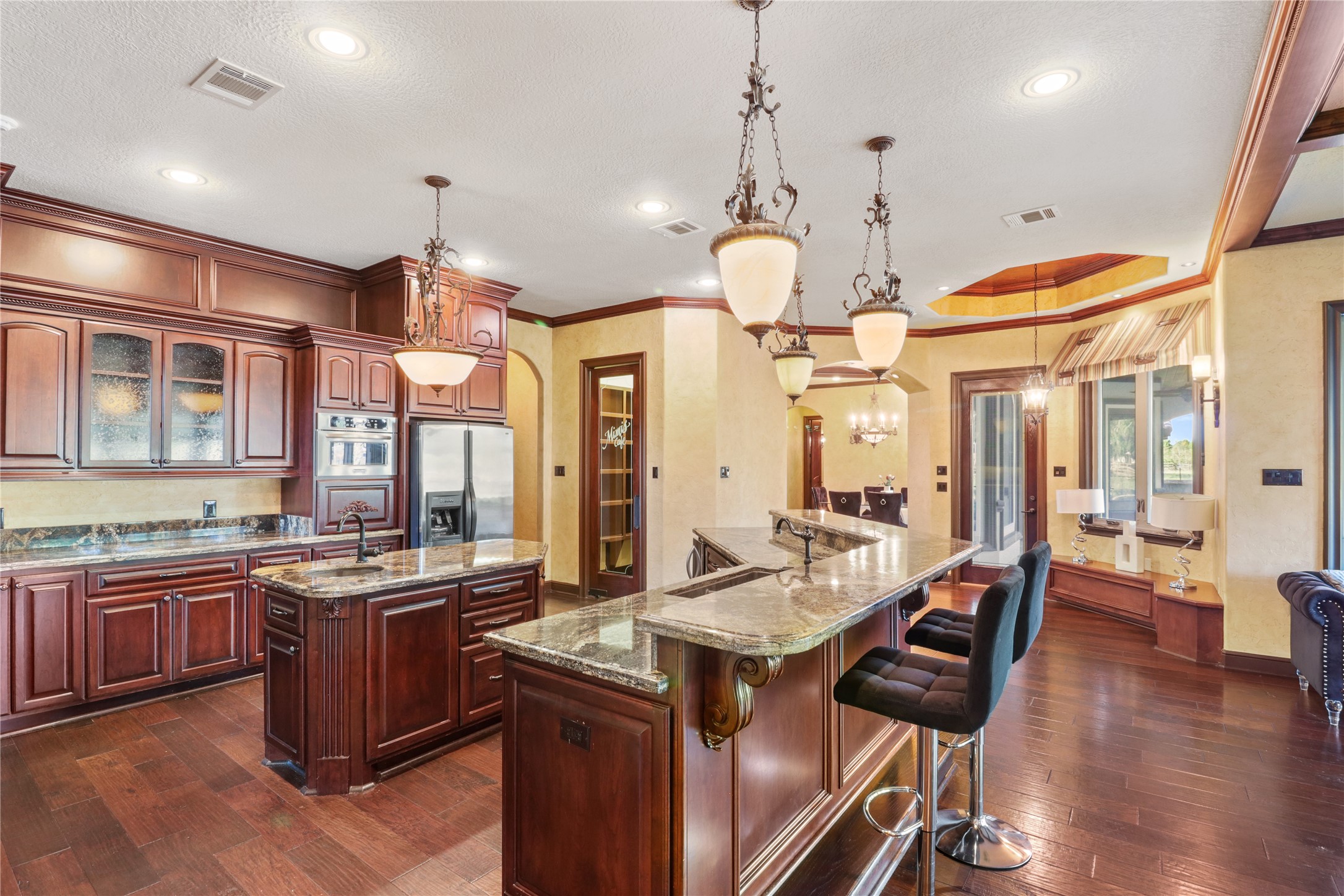 26325 Bauer Hockley Road Hockley, TX 77447 - Photo 35 of 40 a kitchen with stainless steel appliances granite countertop a stove a refrigerator a kitchen island a sink and chairs