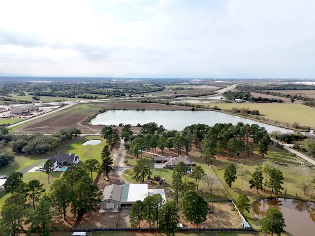 an aerial view of lake and residential houses with outdoor space