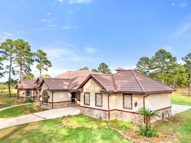a house with a big yard and large trees