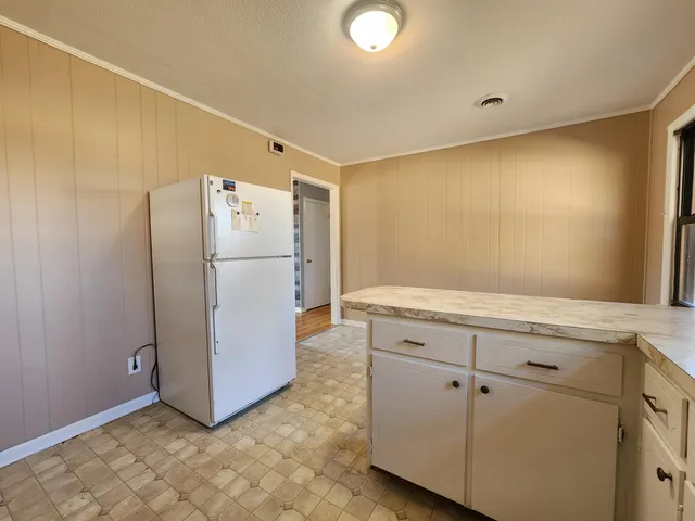 a white refrigerator freezer sitting in a kitchen