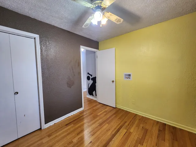 a bathroom with a toilet sink vanity granite and mirror