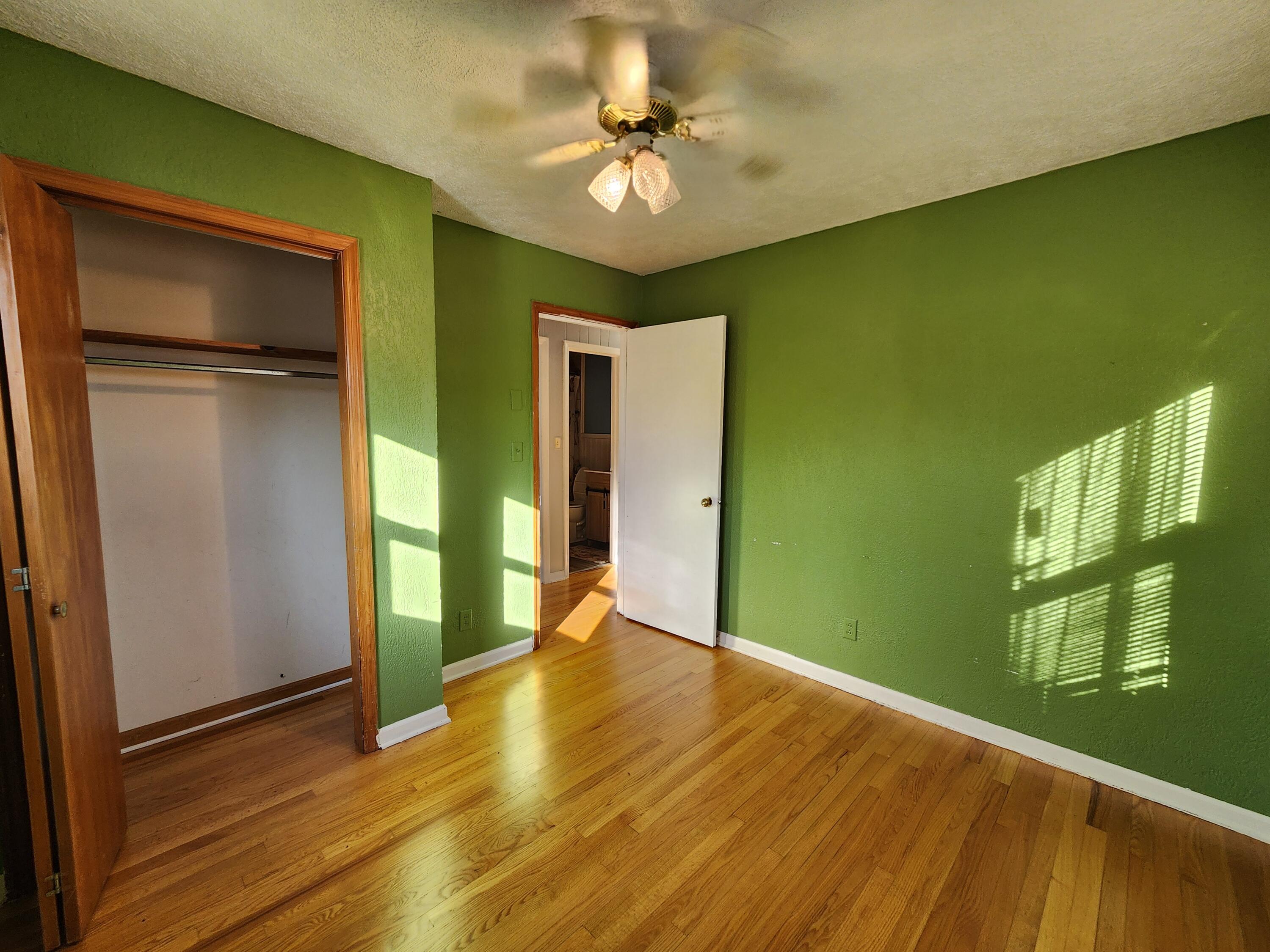 10519 Henry Road Henry, VA 24102 - Photo 21 of 26 a view of an empty room with window and wooden floor