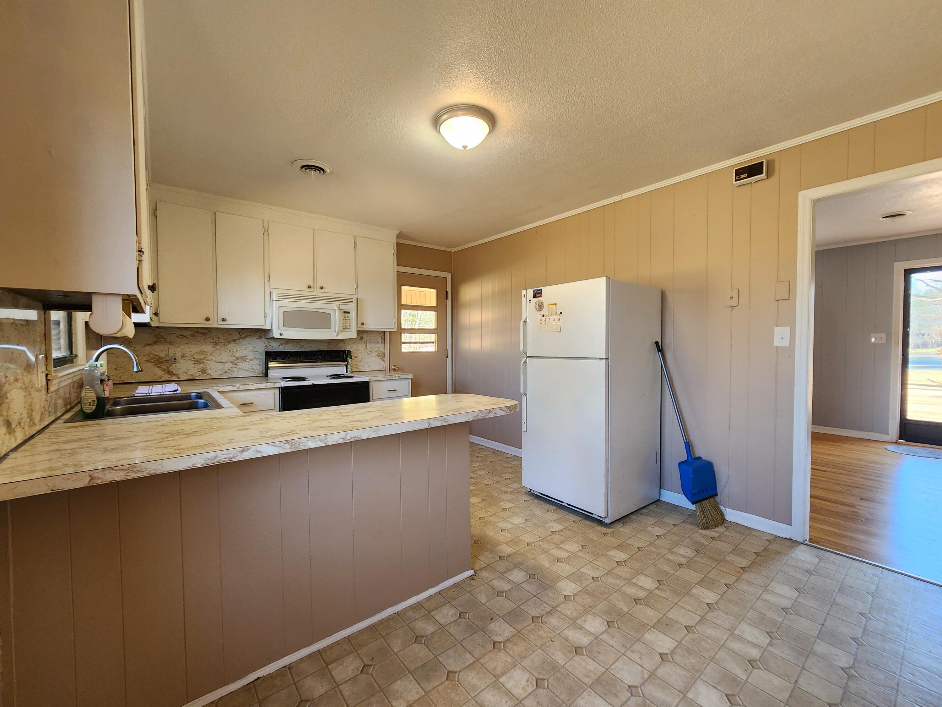 10519 Henry Road Henry, VA 24102 - Photo 9 of 26 a kitchen with refrigerator and cabinets