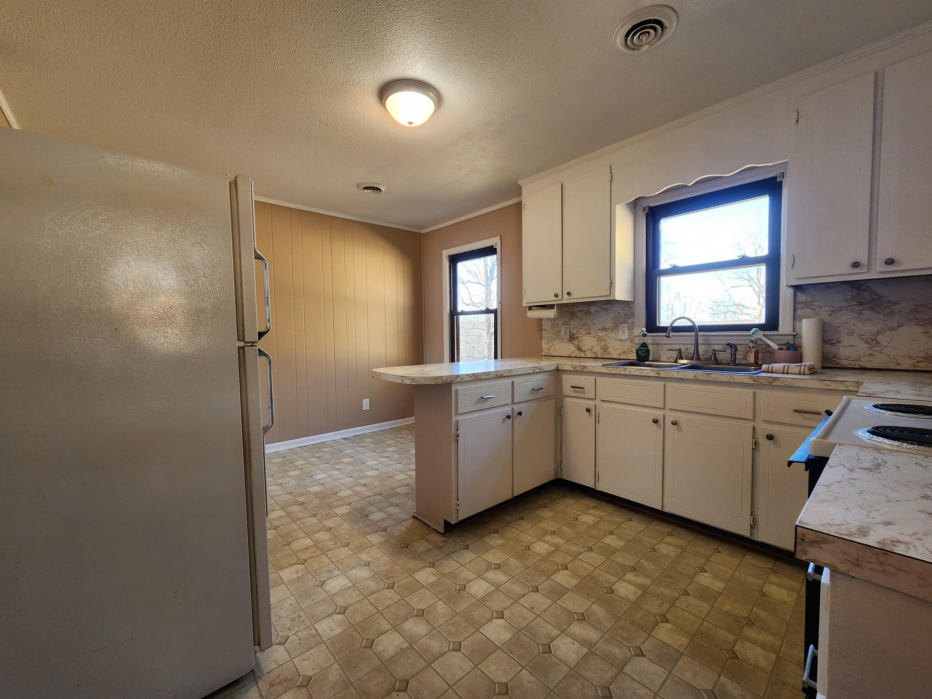 10519 Henry Road Henry, VA 24102 - Photo 10 of 26 a kitchen with a sink cabinets appliances and a window