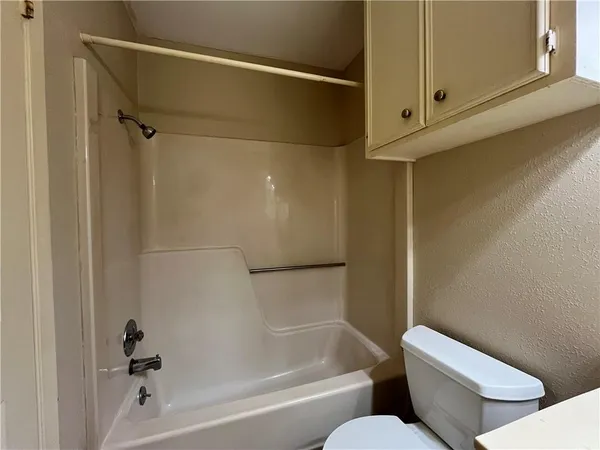 a view of a livingroom with wooden floor and a ceiling fan