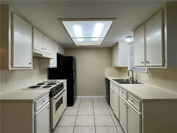 a kitchen with a refrigerator stove and cabinets