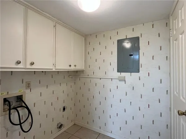 a view of an empty room with a chandelier fan