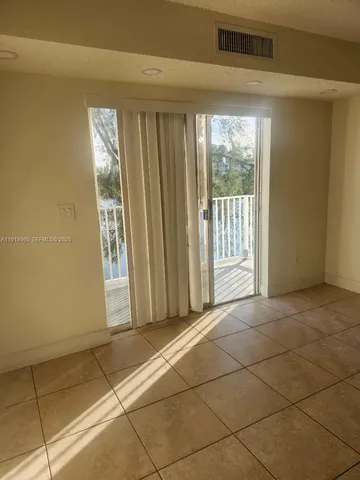 a view of a livingroom with an empty space and a chandelier fan