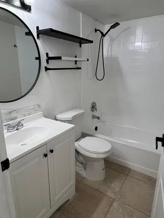 a bathroom with a toilet sink and shower