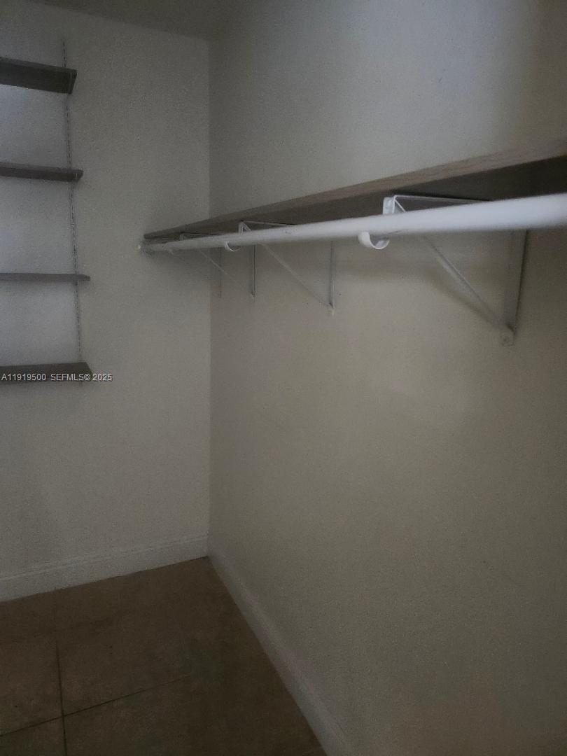 8240 Southwest 210th Street, Unit 220 Cutler Bay, FL 33189 - Photo 21 of 23 a view of a room with racks on the wall