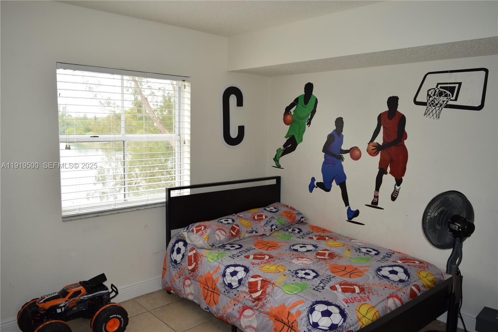 8240 Southwest 210th Street, Unit 220 Cutler Bay, FL 33189 - Photo 7 of 23 a bedroom with a bed and a window