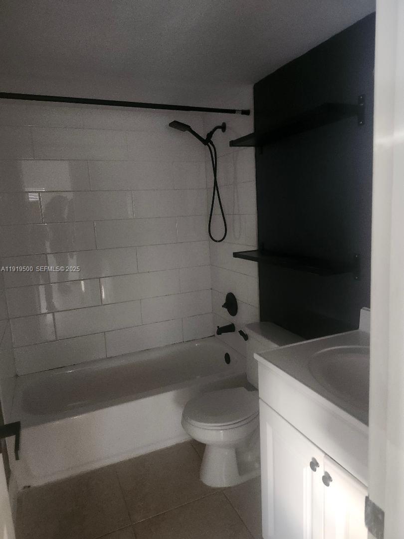 8240 Southwest 210th Street, Unit 220 Cutler Bay, FL 33189 - Photo 8 of 23 a bathroom with a shower and a toilet