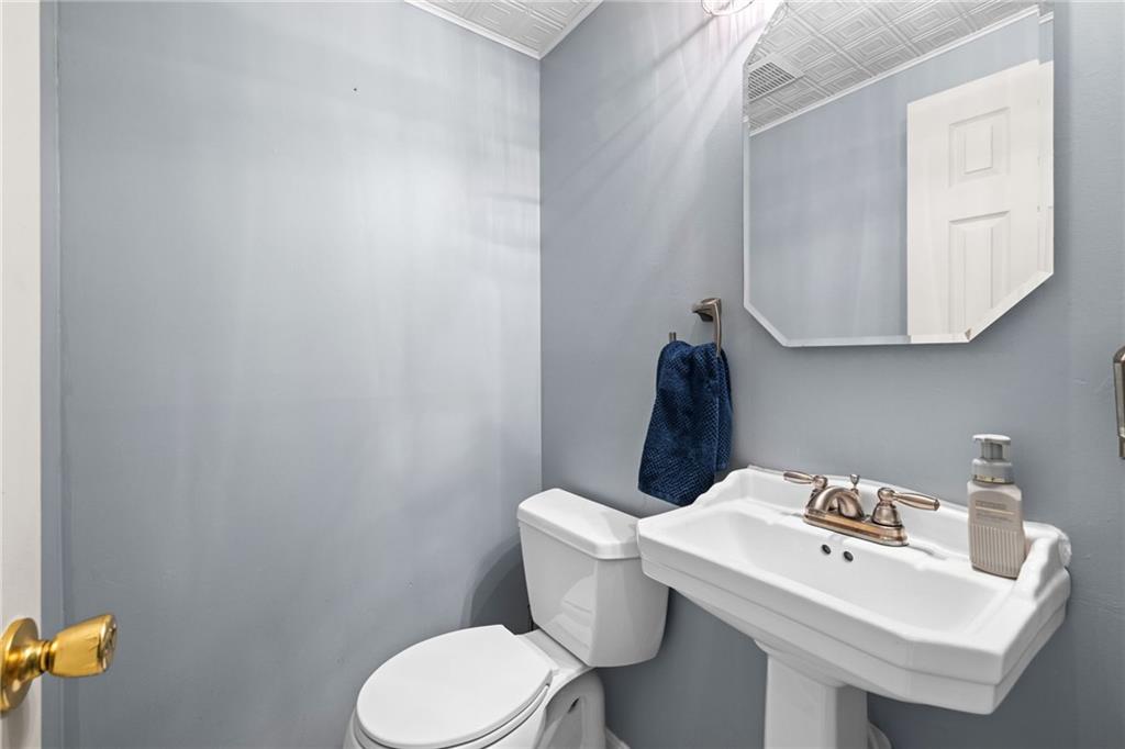 1335 Alamae Lakes Road Washington, PA 15301 - Photo 12 of 50 a bathroom with a toilet a sink and mirror