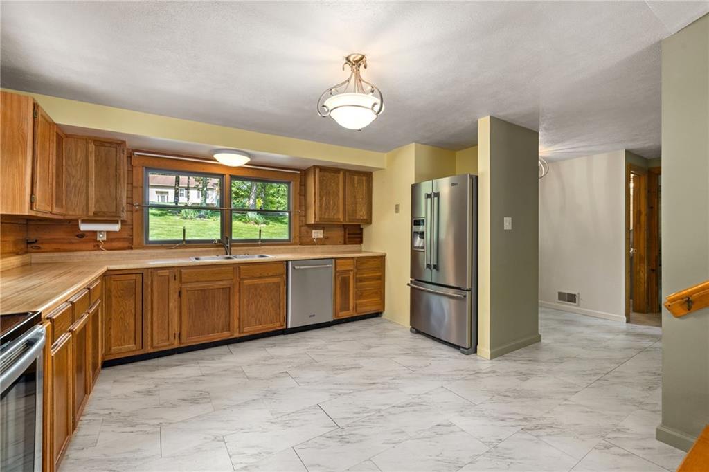 1335 Alamae Lakes Road Washington, PA 15301 - Photo 14 of 50 a kitchen with a stove a refrigerator and a sink