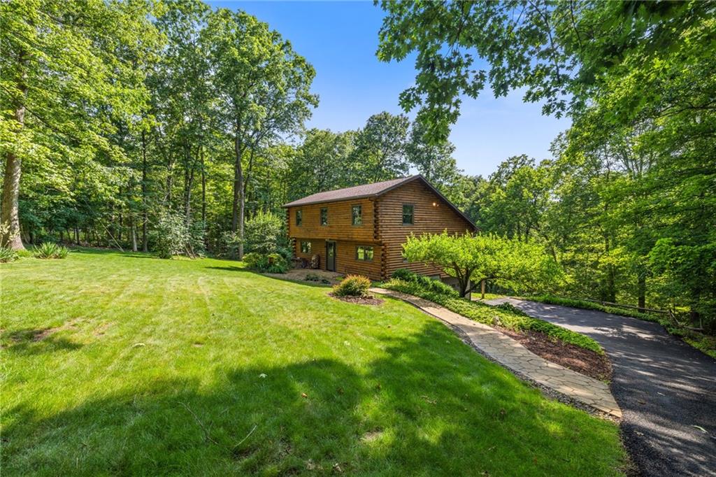 1335 Alamae Lakes Road Washington, PA 15301 - Photo 3 of 50 a backyard of a house with plants and large trees