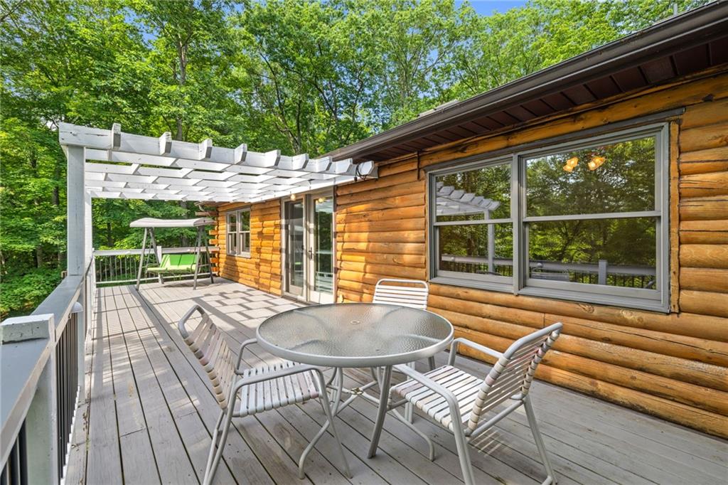 1335 Alamae Lakes Road Washington, PA 15301 - Photo 36 of 50 a view of patio with table and chairs and wooden floor