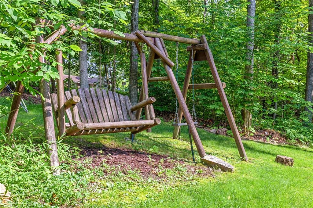 1335 Alamae Lakes Road Washington, PA 15301 - Photo 45 of 50 a view of a backyard with a slide trees and wooden fence