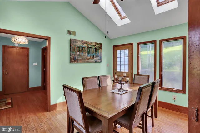 a dining room with furniture a window and wooden floor