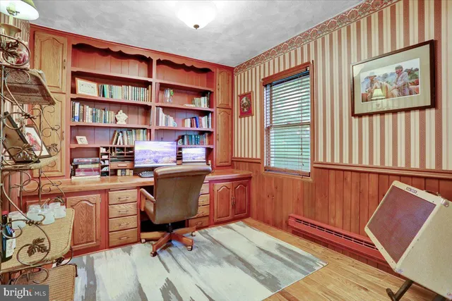 a living room with furniture wooden floor and a large window