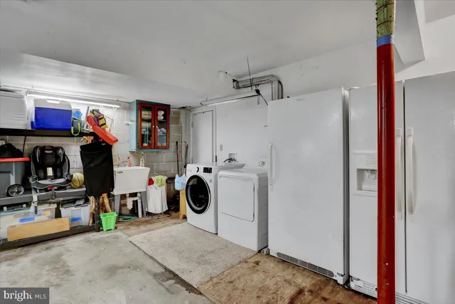 a kitchen with stainless steel appliances granite countertop a stove a sink dishwasher and a dining table with bookshelf