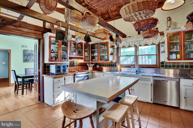 a kitchen with stainless steel appliances granite countertop a stove and a sink