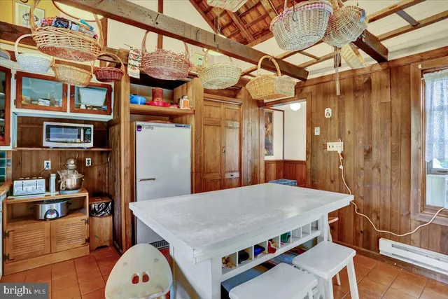 a dining room with furniture window and wooden floor