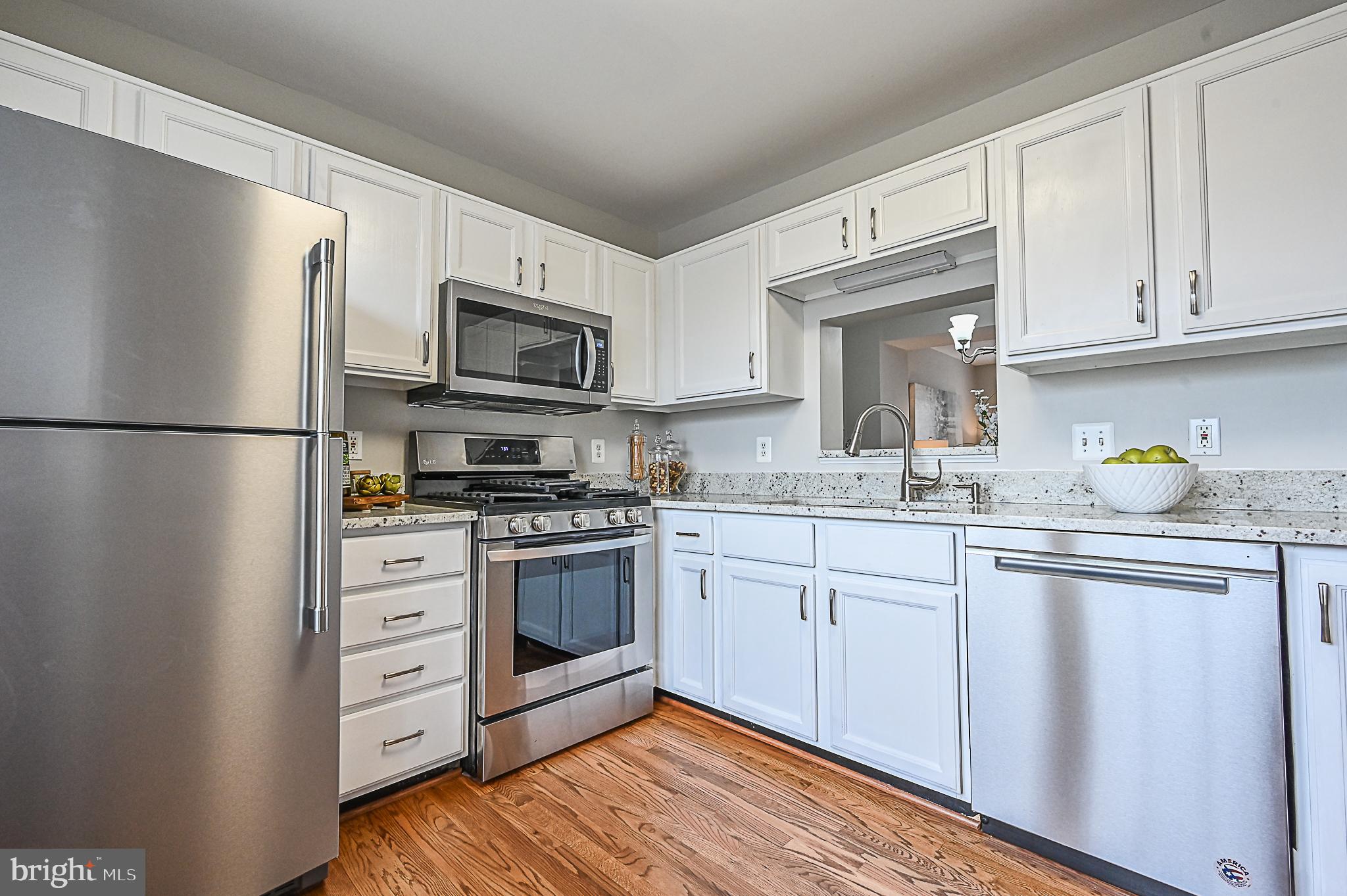 6356 Racetec Place Springfield, VA 22150 - Photo 11 of 51 a kitchen with cabinets stainless steel appliances and a counter space