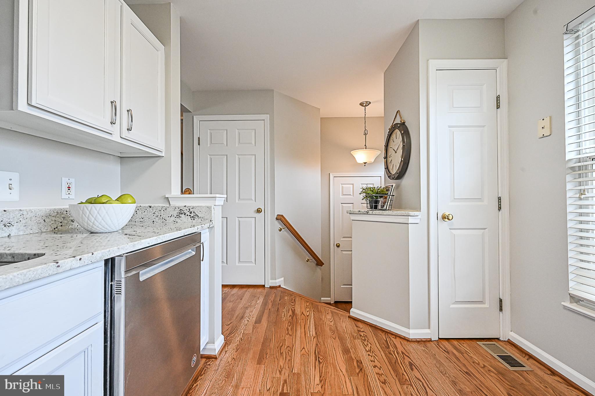 6356 Racetec Place Springfield, VA 22150 - Photo 12 of 51 a kitchen with a sink a refrigerator and cabinets