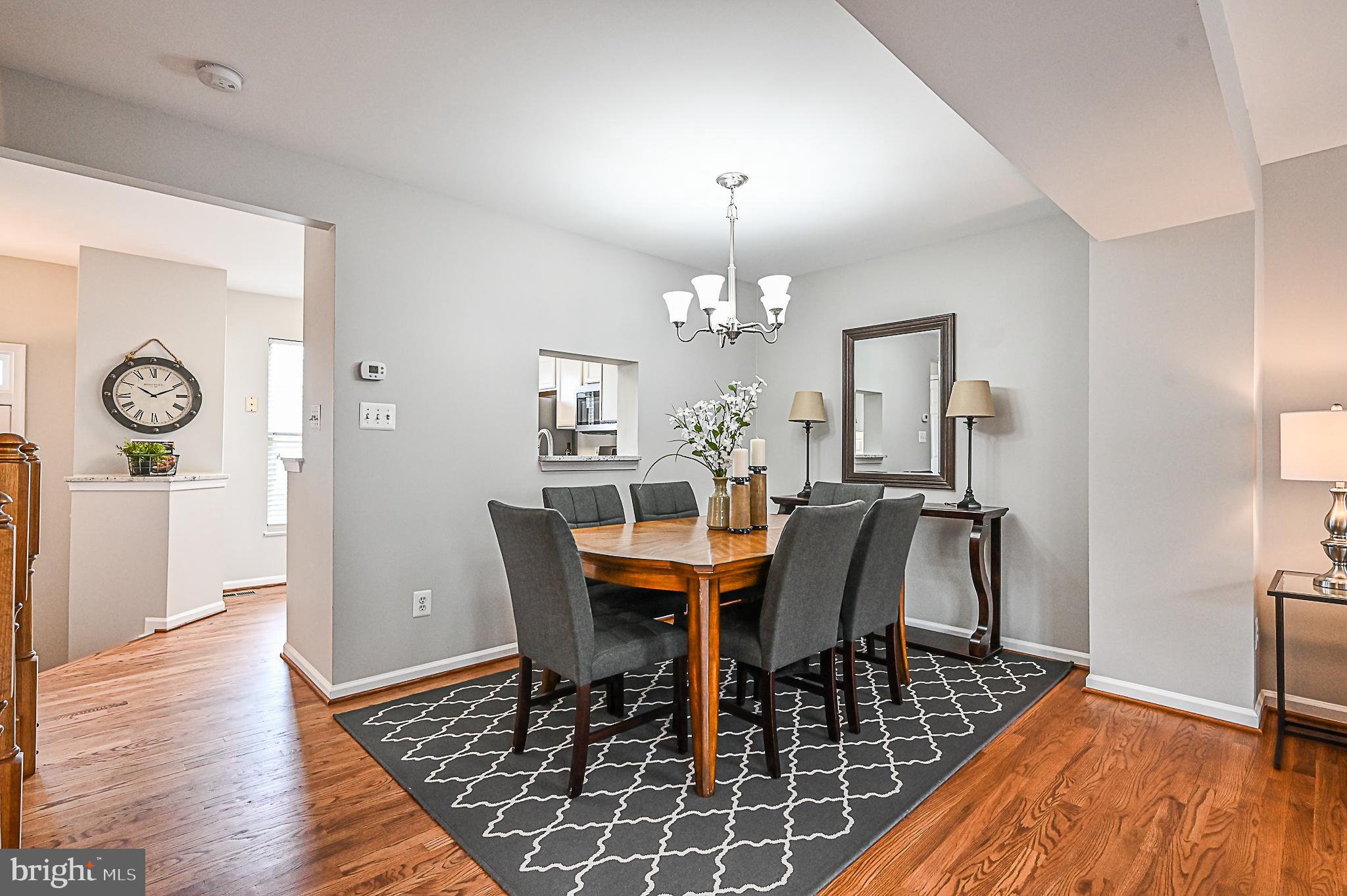 6356 Racetec Place Springfield, VA 22150 - Photo 16 of 51 a view of a dining room with furniture and wooden floor