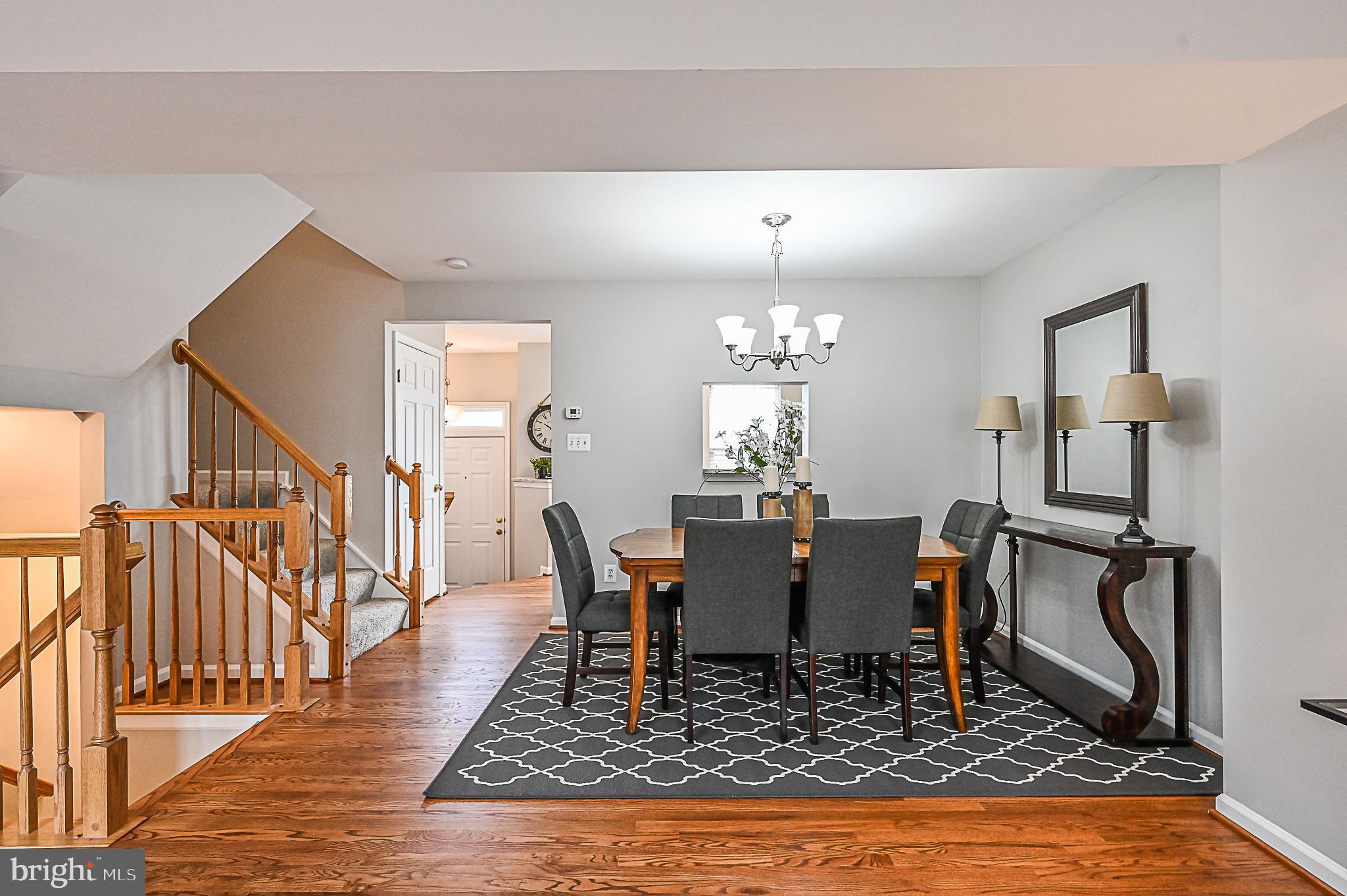6356 Racetec Place Springfield, VA 22150 - Photo 17 of 51 a living room with dining room and wooden floor