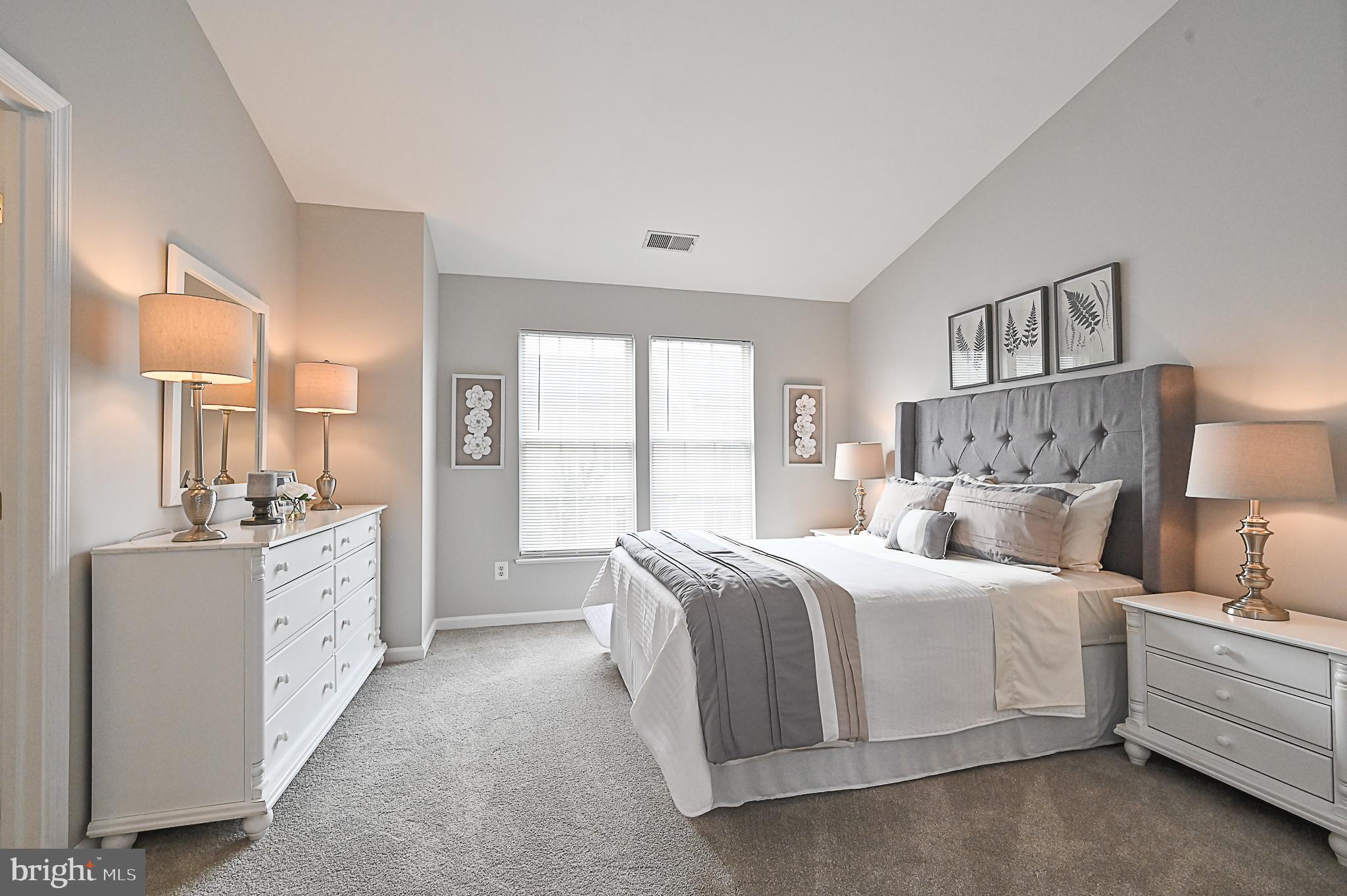 6356 Racetec Place Springfield, VA 22150 - Photo 25 of 51 a spacious bedroom with a bed and a couch