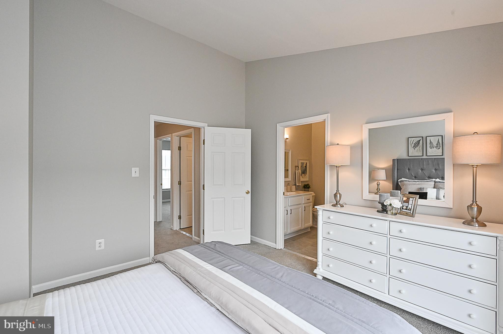 6356 Racetec Place Springfield, VA 22150 - Photo 27 of 51 a bedroom with a bed and a large mirror