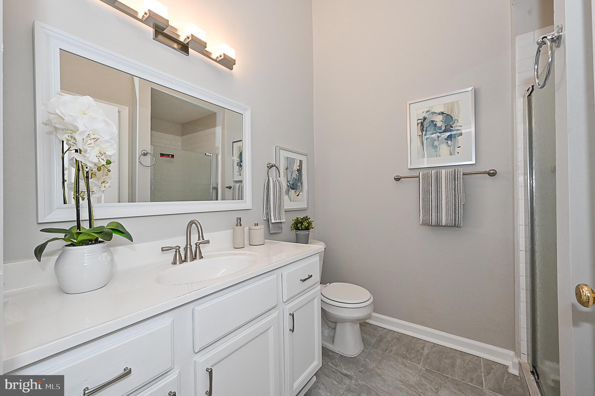 6356 Racetec Place Springfield, VA 22150 - Photo 29 of 51 a bathroom with a toilet sink and mirror