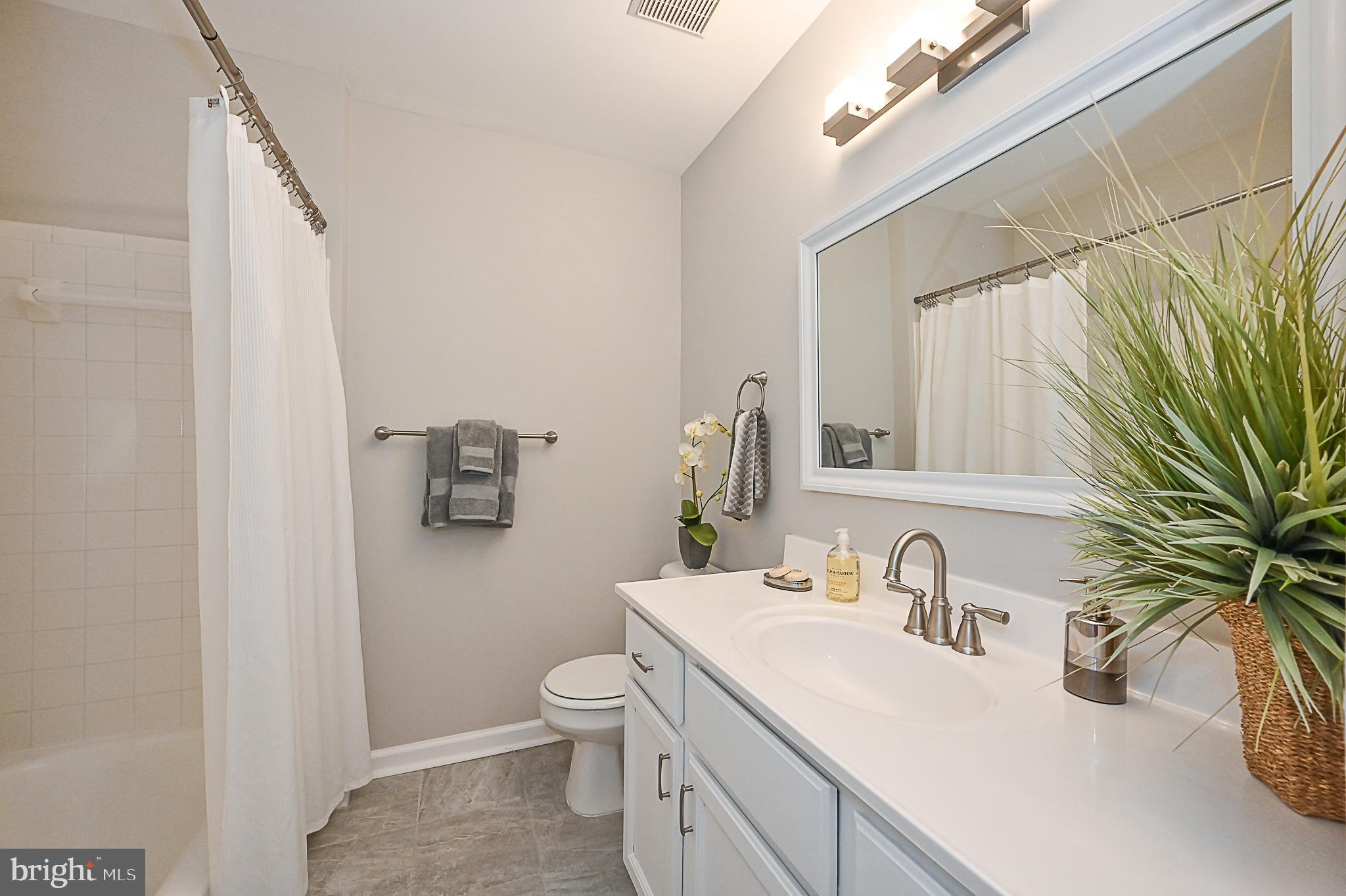 6356 Racetec Place Springfield, VA 22150 - Photo 37 of 51 a bathroom with a sink a toilet and a mirror
