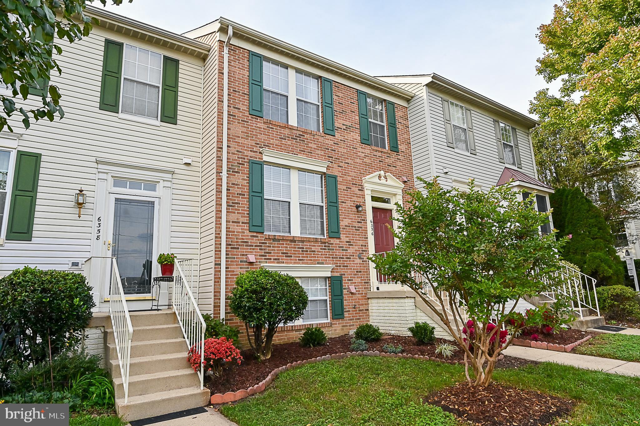 6356 Racetec Place Springfield, VA 22150 - Photo 49 of 51 a front view of a house with a yard and trees