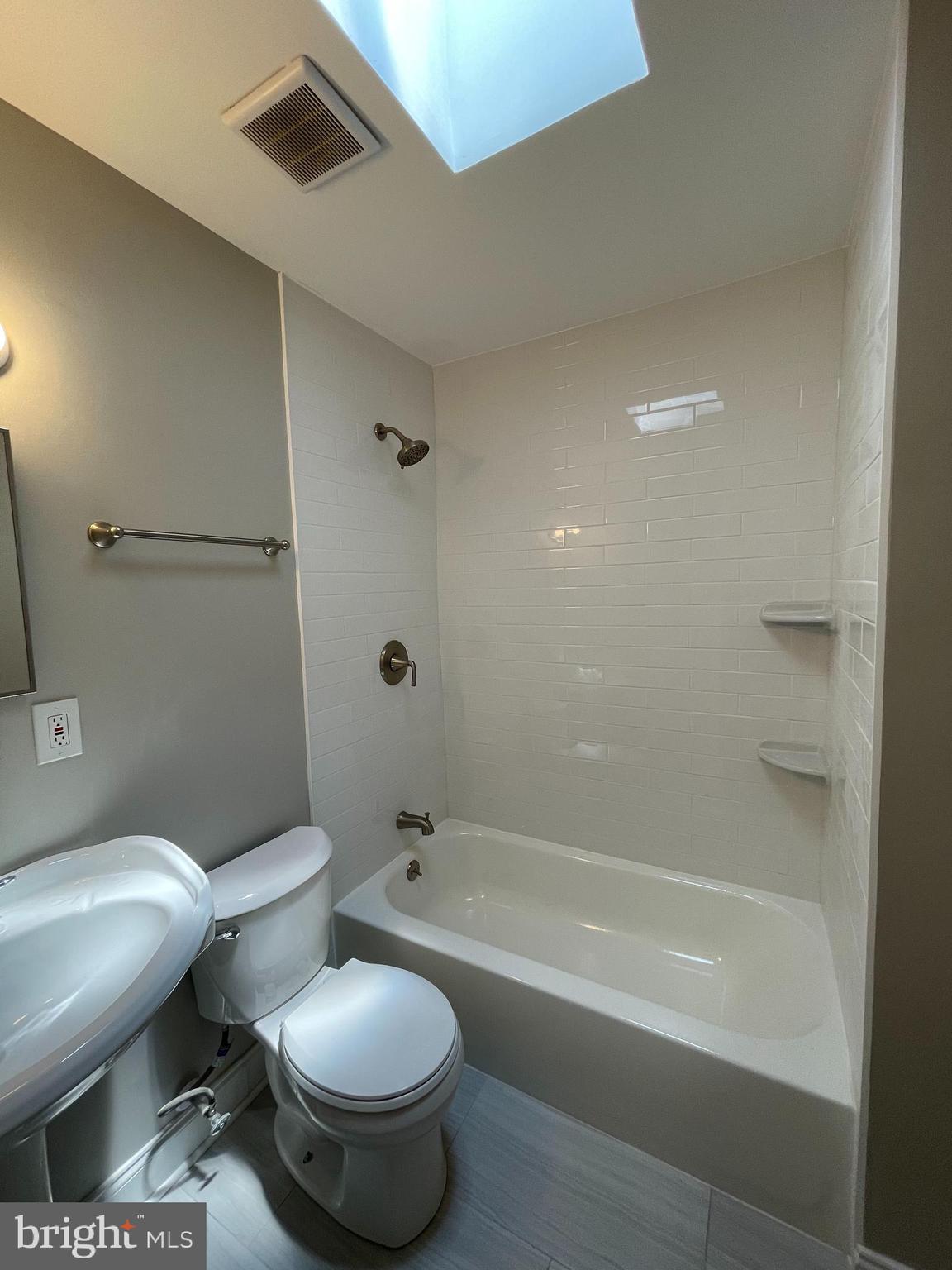 2830 Edgecombe Circle South Baltimore, MD 21215 - Photo 27 of 32 a white toilet sitting next to a bath tub