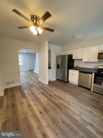 a view of a kitchen with a sink and cabinets