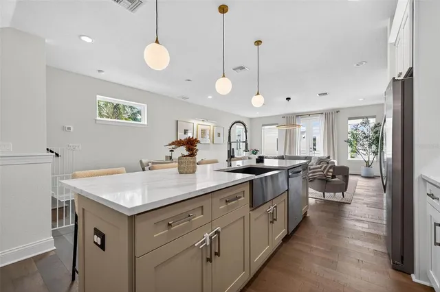 a kitchen with a sink dishwasher a stove and a refrigerator with wooden floor