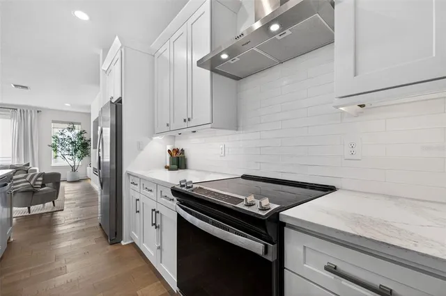a kitchen with a stove and a refrigerator
