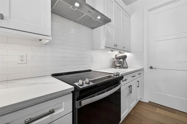 a stove top oven sitting inside of a kitchen