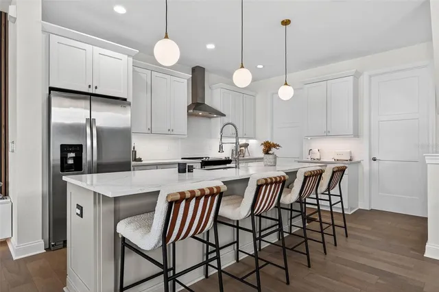 a kitchen with a dining table chairs sink and cabinets