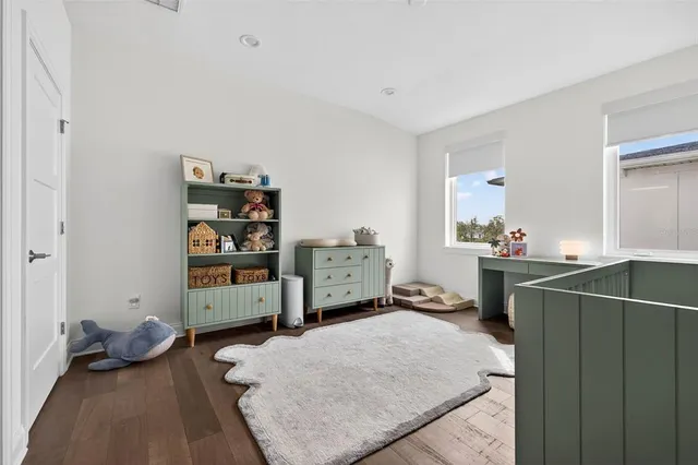 a bedroom with baby crib and a window