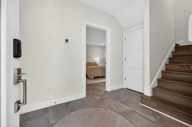 a view of hallway with stairs and a closet