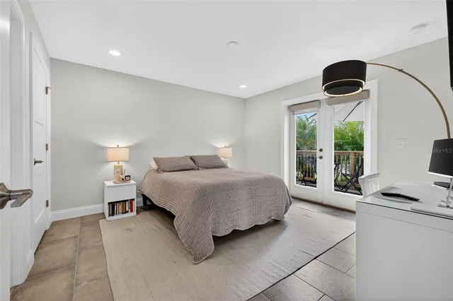 a bedroom with a bed and a large window