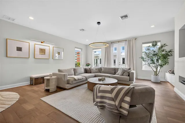 a living room with furniture potted plant and a window