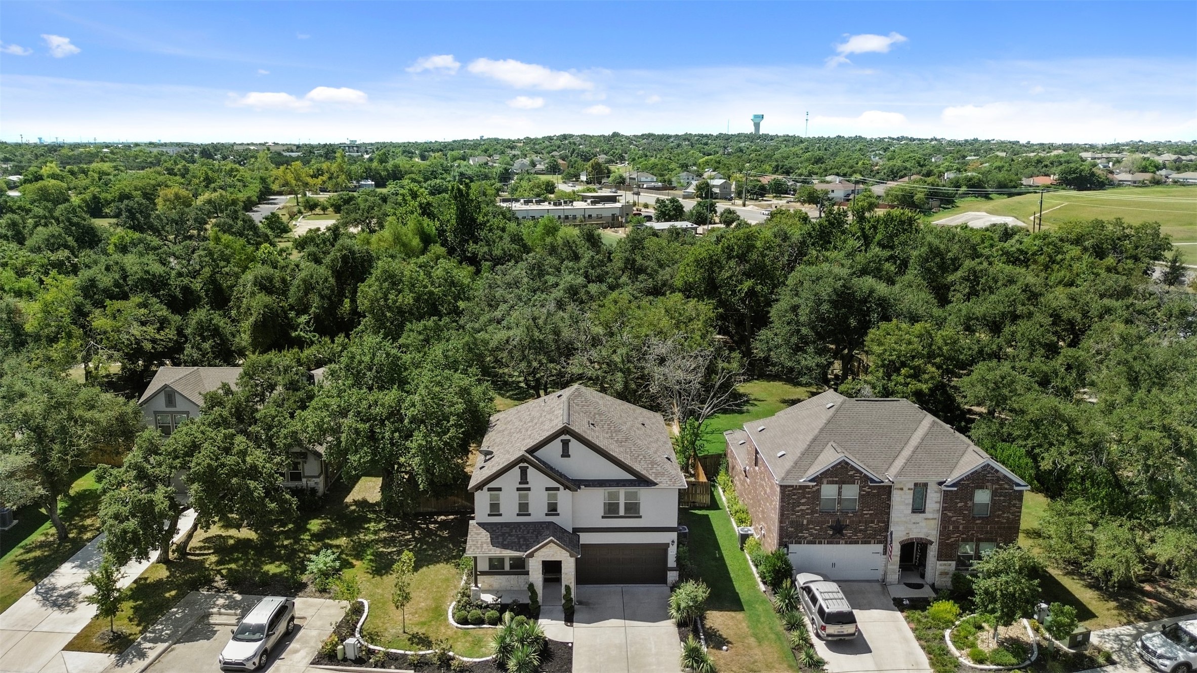 904 American Trail, Unit 2 Leander, TX 78641 - Photo 2 of 29 Aerial view of residential area featuring a tree filled landscape.