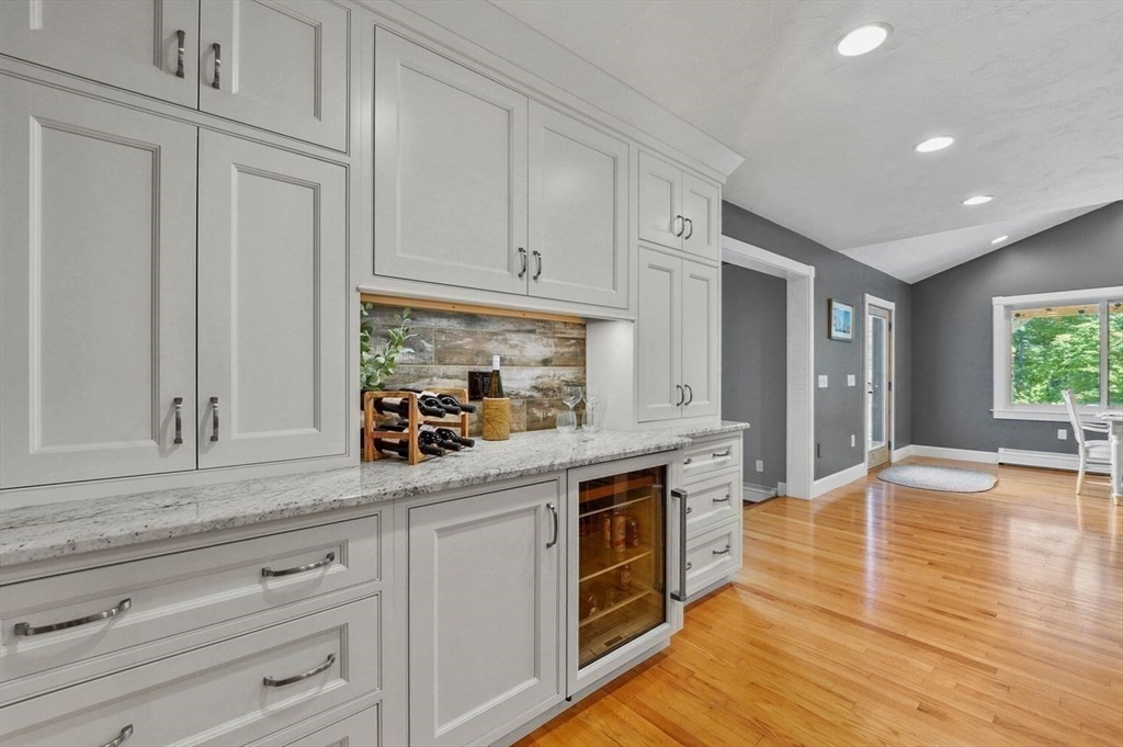 31 Douglas Road Sutton, MA 01590 - Photo 13 of 42 a kitchen with stainless steel appliances granite countertop a refrigerator a stove and white cabinets with wooden floor