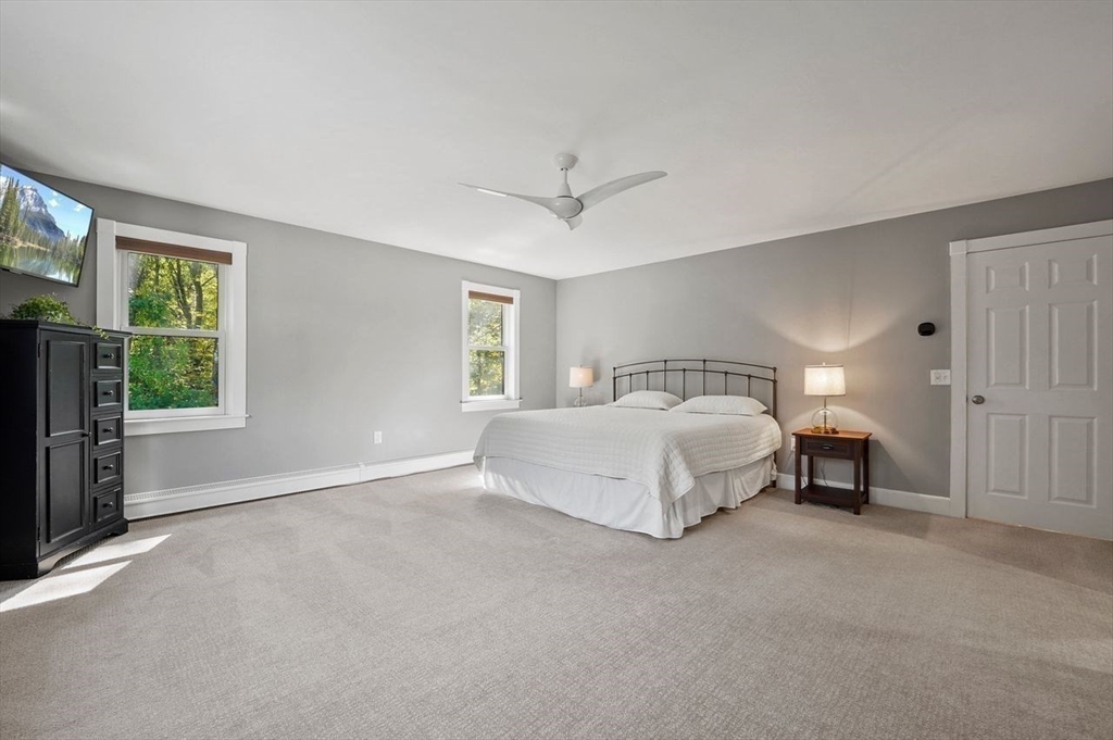 31 Douglas Road Sutton, MA 01590 - Photo 20 of 42 a spacious bedroom with a bed and a ceiling fan